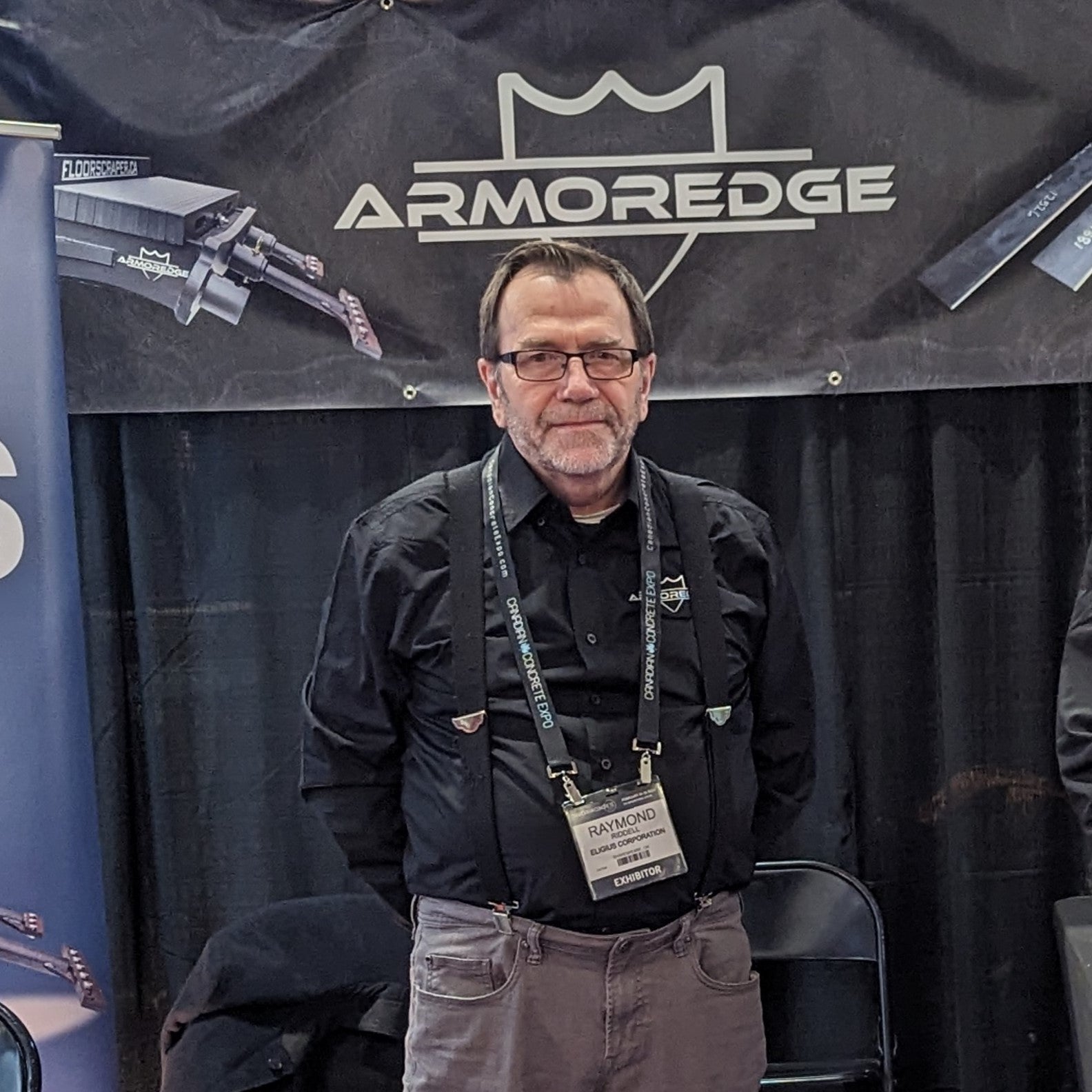 Man standing in front of an Armoredge branded backdrop